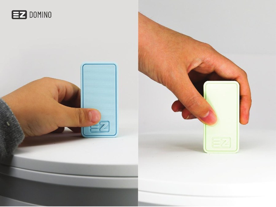 A hand demonstrating the intuitive grip and placement of an EZ Domino piece